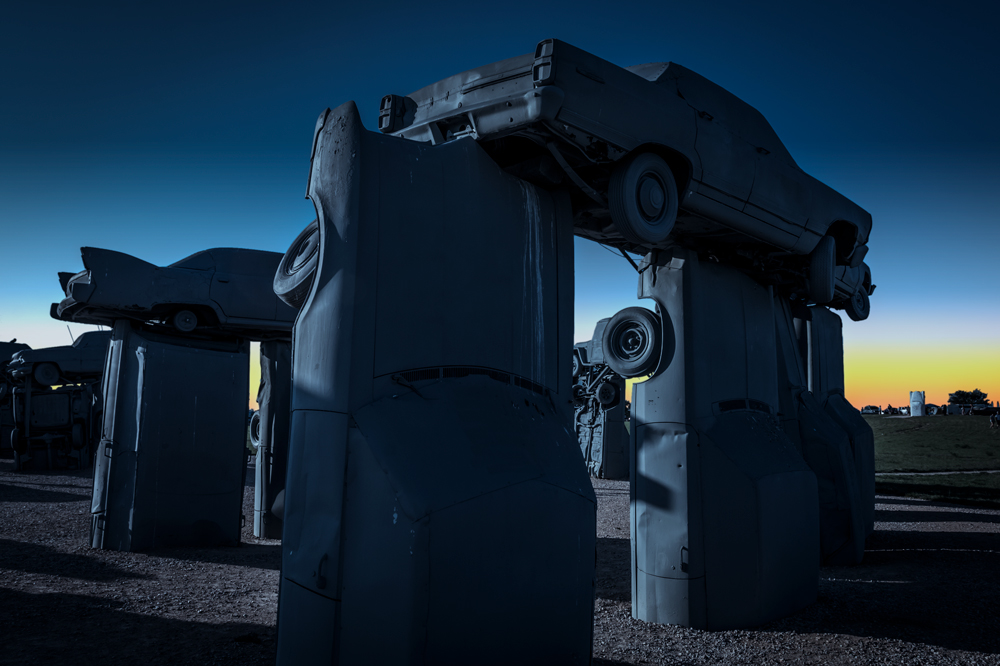 Carhenge with a darkened sky and added sunset