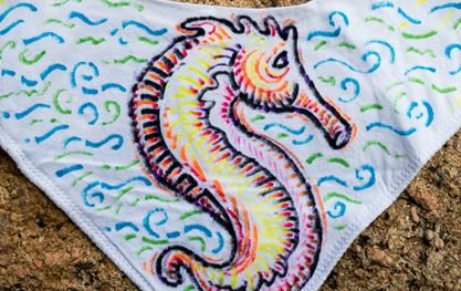 A seahorse hand drawn on a baby bib